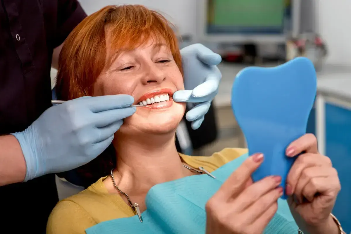 Woman with red hair smiling during dental exam at Las Vegas dental practice.