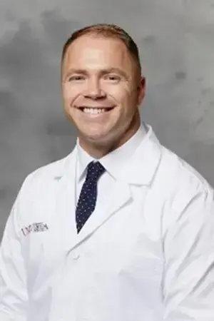 Dr. Emett, dentist at Las Vegas dental practice, smiles in professional portrait.