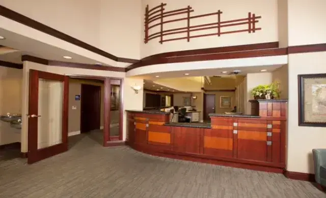 Modern dental office reception area with warm wood cabinetry and welcoming desk space.