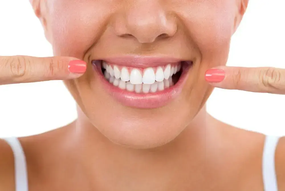 Woman displaying bright white porcelain veneers with a beautiful smile.