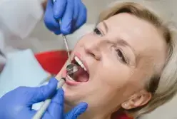 Dentist examining patient's teeth during sedation dentistry consultation in Las Vegas.