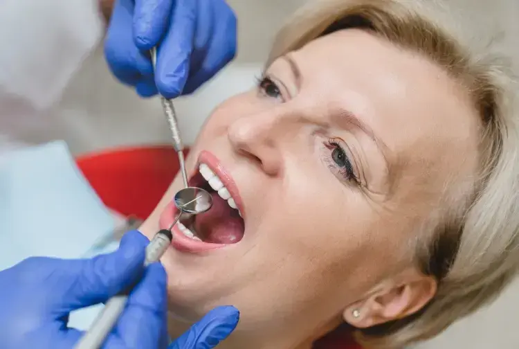 Woman receiving sedation dentistry treatment with dental tools in Las Vegas dental office.