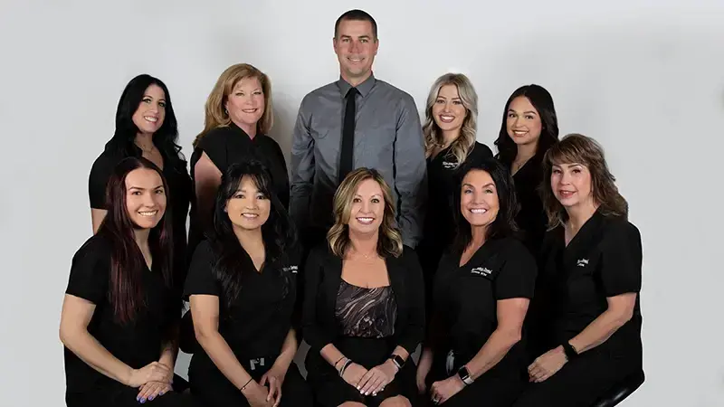 Las Vegas dental practice team portrait with dentist and staff members in professional attire.