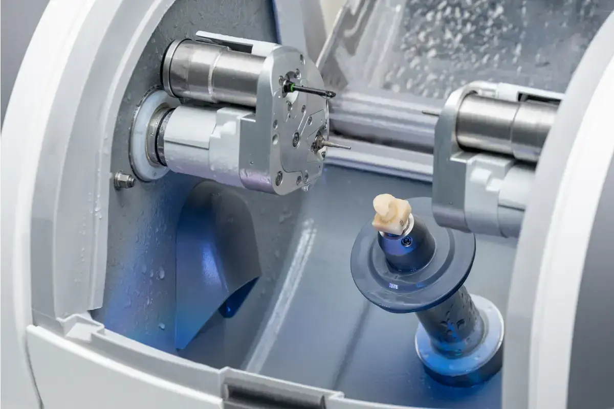 CEREC milling machine with blue solution chamber creating same-day dental crowns.